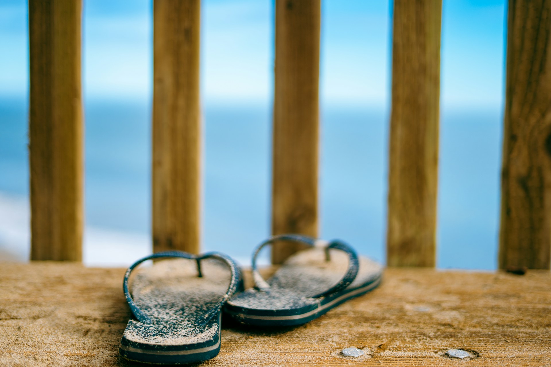 A pair of sandy flip flops