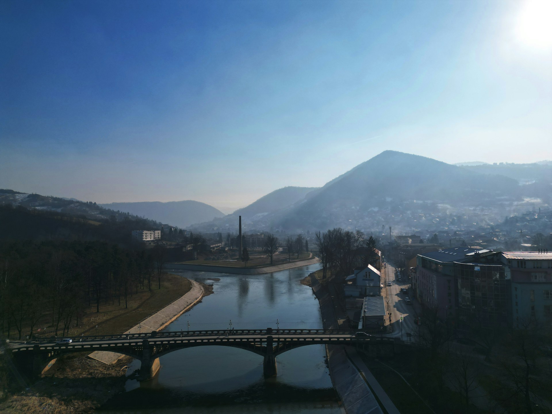 bridge over body of water with mountain in background
