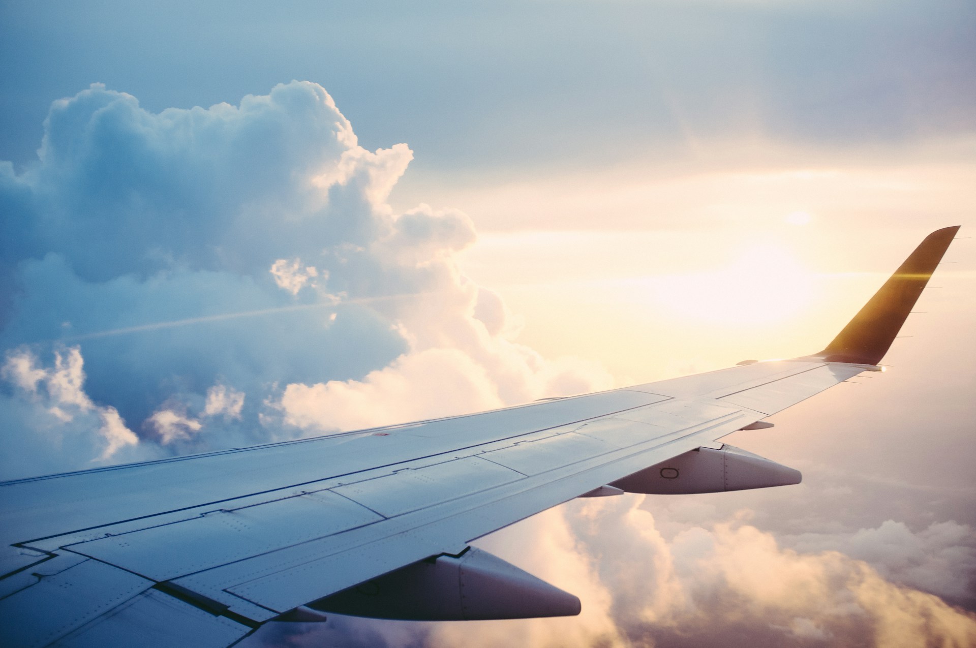 A plane wing over sunset
